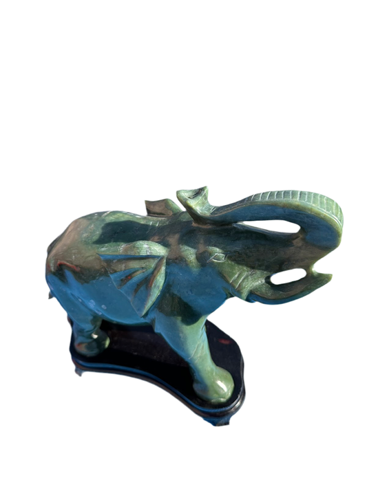 This is a hand-carved Nephrite jade sculpture depicting happy elephant, complete with the artist's signature.